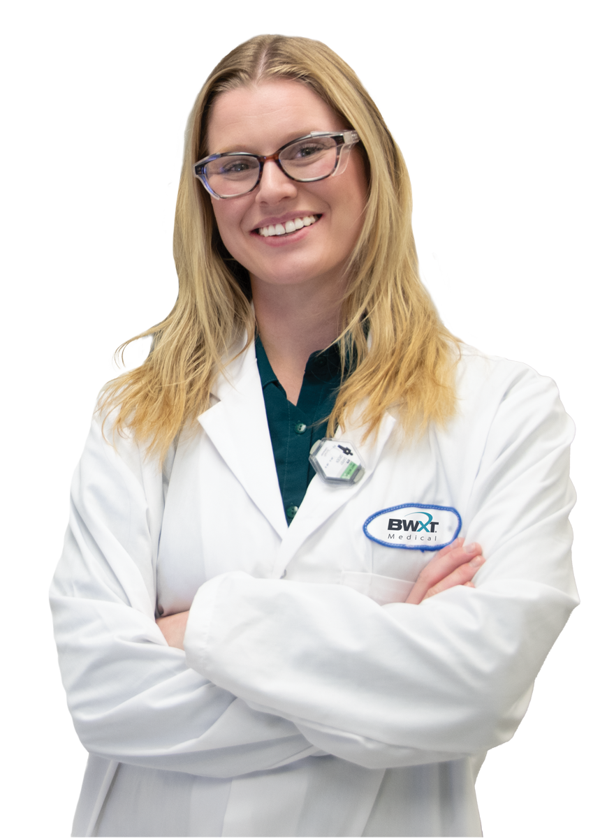 BWXT medical employee woman in a white lab coat with safety glasses blonde hair BWXT employee