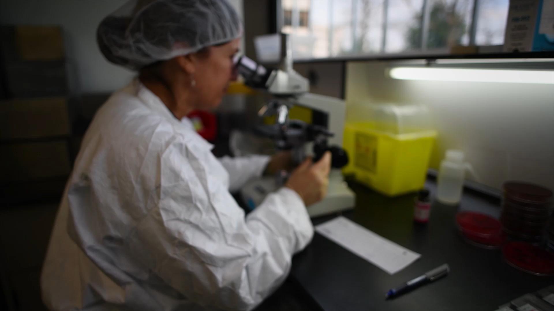 BWXT scientist employee white lab coat microscope